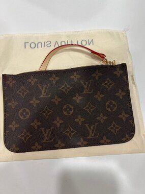 SOURCE UNKNOWN Slim, zippered accessory crafted from coated canvas.